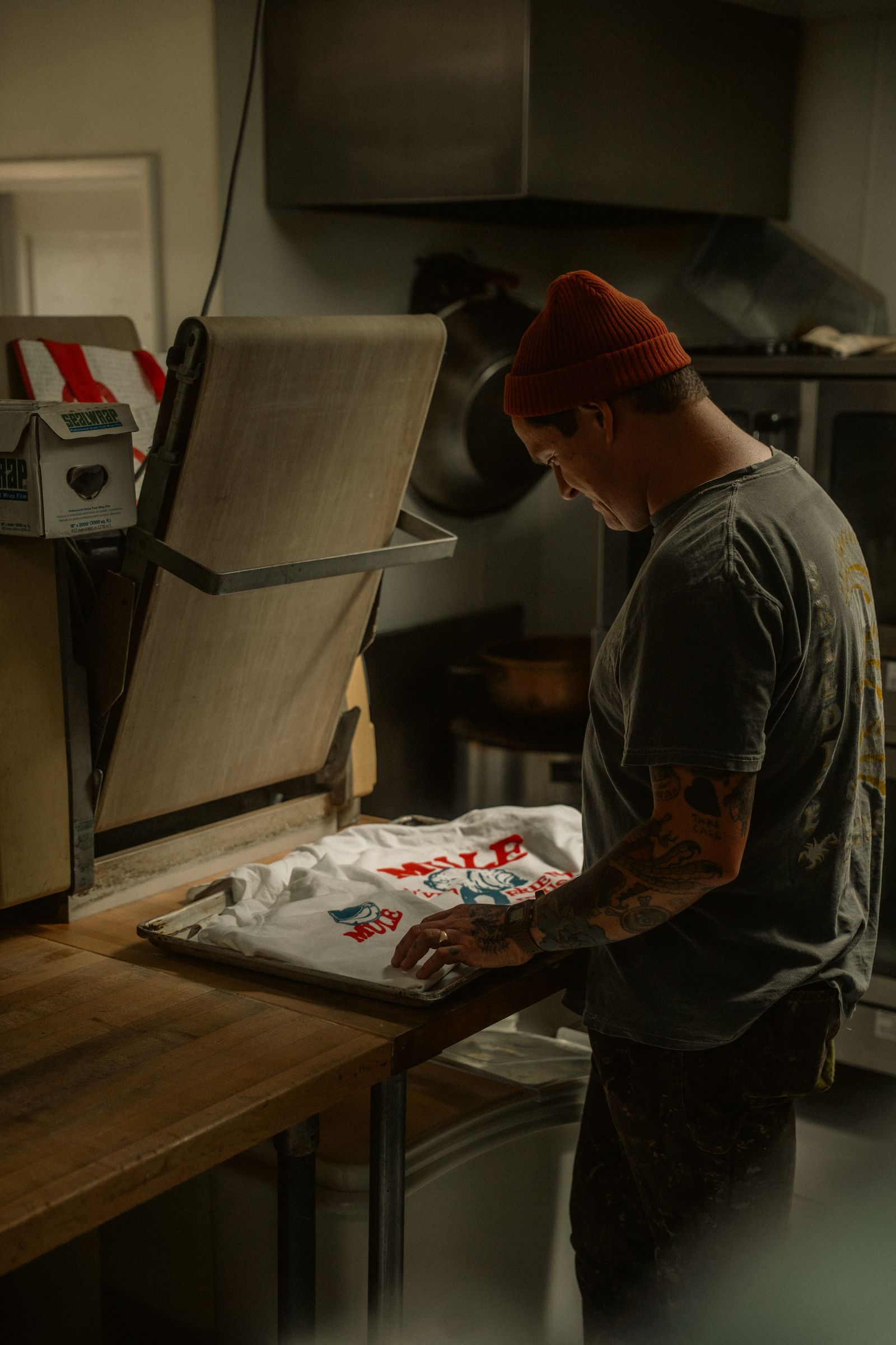 A worker prepares a T-shirt for printing